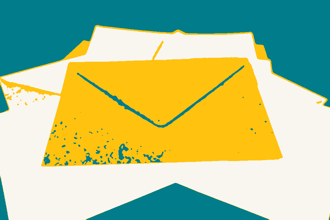 A pile of coloured envelopes on an orange surface.